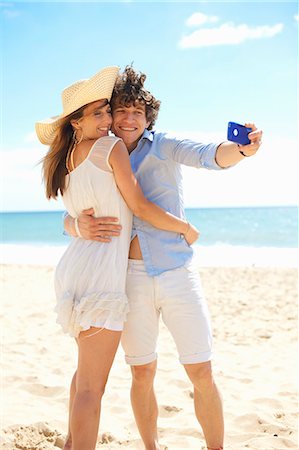 smartphone at beach - Couple self photographing with mobile phone on beach Stock Photo - Premium Royalty-Free, Code: 649-07238867