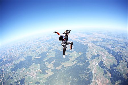 escape outdoors fun - Female skydiver free falling above Leutkirch, Bavaria, Germany Stock Photo - Premium Royalty-Free, Code: 649-07238946