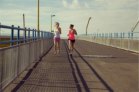 road building - Young female joggers running on bridge Stock Photo - Premium Royalty-Free, Code: 649-07238958