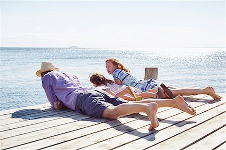 family and happy and outside and play - Family lying on pier, Utvalnas, Gavle, Sweden Stock Photo - Premium Royalty-Free, Code: 649-07238999