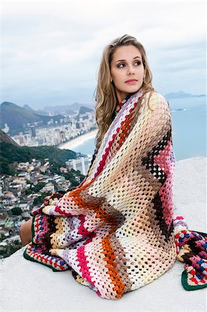 far view - Young woman wrapped in wool blanket, Casa Alto Vidigal, Rio De Janeiro, Brazil Stock Photo - Premium Royalty-Free, Code: 649-07239105