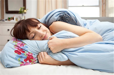 duvet - Young woman in bed with eyes closed Stock Photo - Premium Royalty-Free, Code: 649-07239126