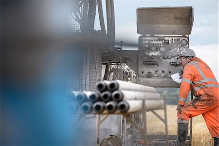 Drilling rig worker inspecting machinery Stock Photo - Premium Royalty-Free, Code: 649-07239194