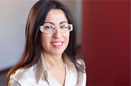 Portrait of brunette businesswoman wearing glasses Stock Photo - Premium Royalty-Free, Code: 649-07239282
