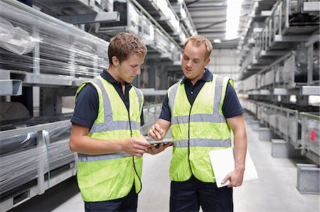 paper work stacked - Workers checking orders in engineering warehouse Stock Photo - Premium Royalty-Free, Code: 649-07239374
