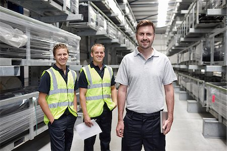 paper work stacked - Portrait of three workers in engineering warehouse Stock Photo - Premium Royalty-Free, Code: 649-07239375