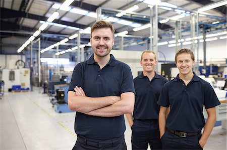 Portrait of three workers in engineering factory Stock Photo - Premium Royalty-Free, Code: 649-07239370