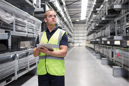 factory interior - Worker checking order in engineering warehouse Stock Photo - Premium Royalty-Free, Code: 649-07239372