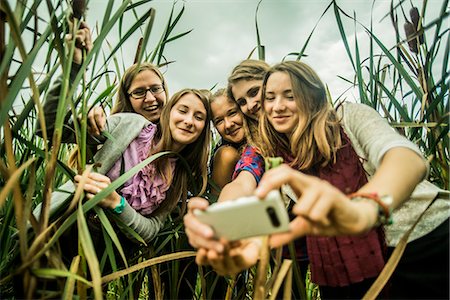 simsearch:649-07239413,k - Five young women taking self portrait in marshes Stock Photo - Premium Royalty-Free, Code: 649-07239415