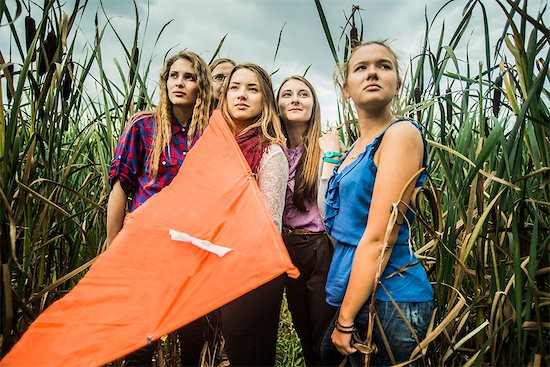 Portrait of five young women in marshes holding kite Stock Photo - Premium Royalty-Free, Image code: 649-07239413