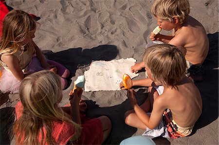 friendship drawing - Four friends eating ice creams on beach, high angle, Wales, UK Stock Photo - Premium Royalty-Free, Code: 649-07239465