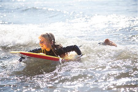 Portrait of girl on surfboard, Wales, UK Stockbilder - Premium RF Lizenzfrei, Bildnummer: 649-07239473