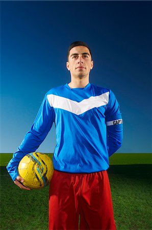 soccer player (male) - Portrait of football team captain holding ball Stock Photo - Premium Royalty-Free, Code: 649-07239539