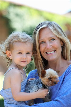 family portrait daughter dog - Portrait of mother holding young daughter and dog Stock Photo - Premium Royalty-Free, Code: 649-07239594