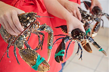 fishmonger female - Women holding fresh lobsters Stock Photo - Premium Royalty-Free, Code: 649-07239617