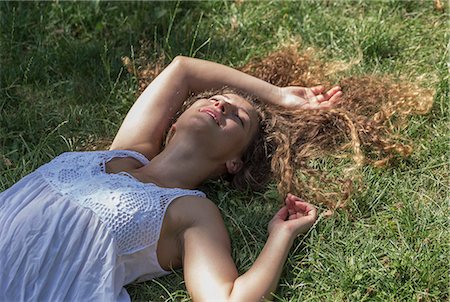 Teenage girl lying on grass, Prague, Czech Republic Stock Photo - Premium Royalty-Free, Code: 649-07239629