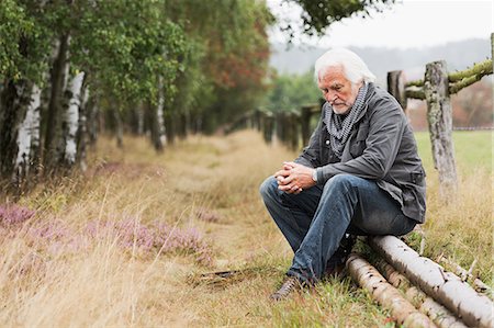 sad 60 year old man - Senior man sitting on log Stock Photo - Premium Royalty-Free, Code: 649-07239714