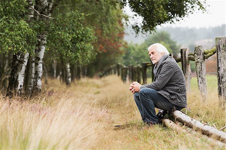 sad - Senior man sitting on log Stock Photo - Premium Royalty-Free, Code: 649-07239713
