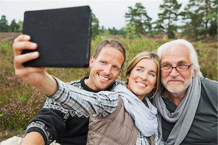 familiengenerationen - Woman holding digital tablet taking photograph Stockbilder - Premium RF Lizenzfrei, Bildnummer: 649-07239767