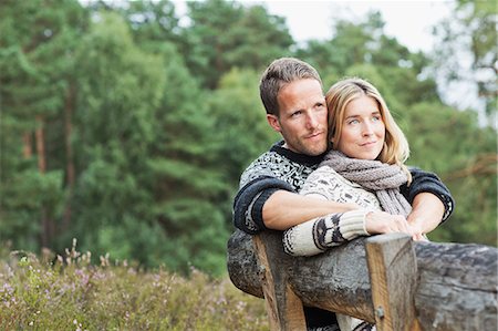 people embracing - Mid adult couple on bench looking away Stock Photo - Premium Royalty-Free, Code: 649-07239776