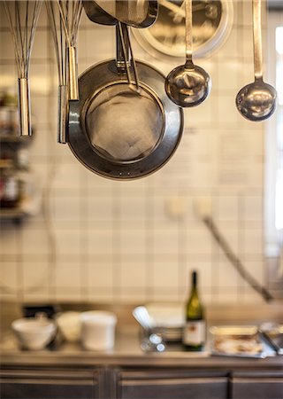 restaurant kitchen - Metal utensils hanging in commercial kitchen Stock Photo - Premium Royalty-Free, Code: 649-07239791