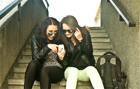 stepping - Two young woman looking at mobile phone Stock Photo - Premium Royalty-Free, Code: 649-07239873