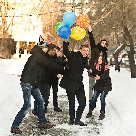 snow laugh - Group of young friends with party hats and balloons Stock Photo - Premium Royalty-Free, Code: 649-07239881