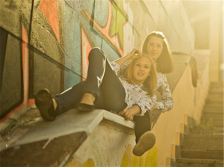 Two young women reclining on stairway Stock Photo - Premium Royalty-Free, Code: 649-07239890