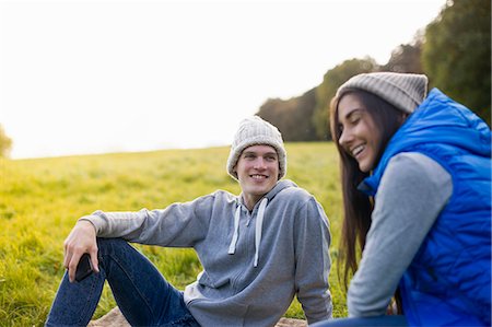 simsearch:649-07521104,k - Young couple sitting on grass laughing Stock Photo - Premium Royalty-Free, Code: 649-07279644