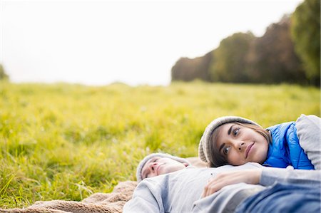 Young woman resting head on man's chest in park Stock Photo - Premium Royalty-Free, Code: 649-07279642