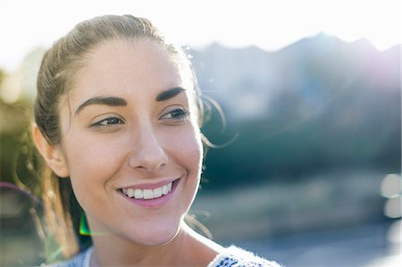 portrait sunshine happy - Portrait of young woman looking away, smiling Stock Photo - Premium Royalty-Free, Code: 649-07279678
