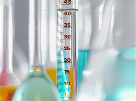Laboratory glassware in lab, Measuring flasks and cylinders containing chemicals during experiment Stock Photo - Premium Royalty-Free, Code: 649-07279762