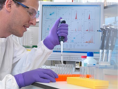 Male scientist pipetting sample into test tubes for analysis of cell population Stock Photo - Premium Royalty-Free, Code: 649-07279824