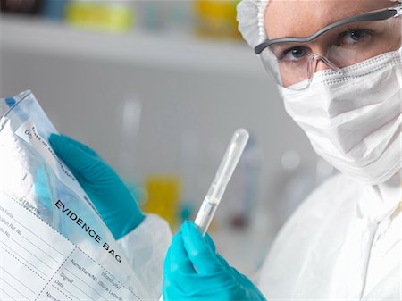 Forensic scientist in laboratory with evidence bag and swab for crime investigation Stock Photo - Premium Royalty-Free, Code: 649-07279844