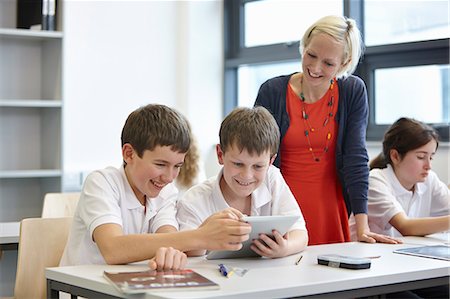 electronic school desk - Schoolchildren working in class with teacher Stock Photo - Premium Royalty-Free, Code: 649-07280086