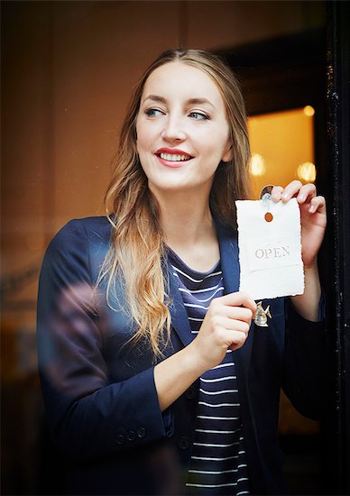 Shop owner with open sign Stock Photo - Premium Royalty-Free, Image code: 649-07280215