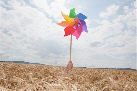 Hand holding windmill in wheat field Stock Photo - Premium Royalty-Free, Code: 649-07280272