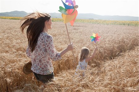 energetic mom outside - Mother and daughter running through wheat field Stock Photo - Premium Royalty-Free, Code: 649-07280284
