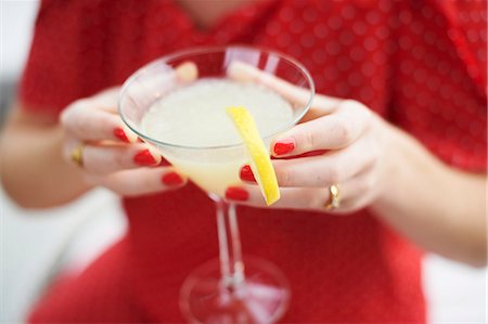 single cocktail - Woman holding glass of cocktail Stock Photo - Premium Royalty-Free, Code: 649-07280335