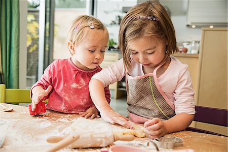 female with apron in kitchen - Children baking in kitchen Stock Photo - Premium Royalty-Free, Code: 649-07280365