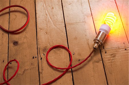 Still life of energy saving lightbulb on wooden floorboards Photographie de stock - Premium Libres de Droits, Code: 649-07280378