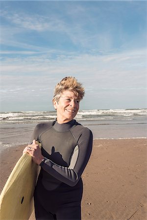 Mature female bodyboarder on Devon beach, UK Stock Photo - Premium Royalty-Free, Code: 649-07280387