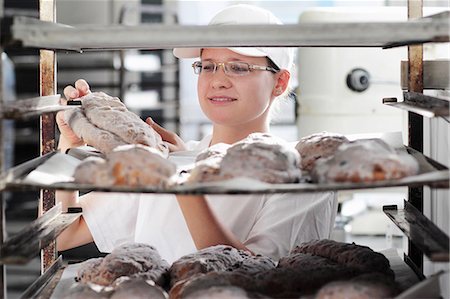 freshly baked bread - Baker putting bread dough on baking sheet Stock Photo - Premium Royalty-Free, Code: 649-07280437