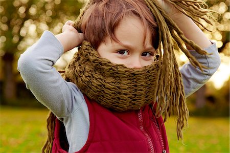 Boy in park, with scarf covering mouth Stock Photo - Premium Royalty-Free, Code: 649-07280613