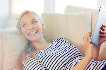 smile happy - Young woman on sofa, using digital tablet Stock Photo - Premium Royalty-Free, Code: 649-07280728