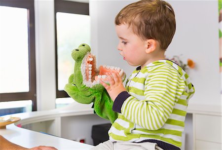 Boy playing with toy crocodile in dentists Stock Photo - Premium Royalty-Free, Code: 649-07280867