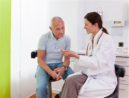 doctor and patient on white - Female doctor talking to senior male patient Stock Photo - Premium Royalty-Free, Code: 649-07280896