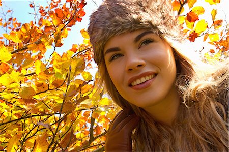 sun flare gold - Young woman in fur hat in autumnal park Stock Photo - Premium Royalty-Free, Code: 649-07280898