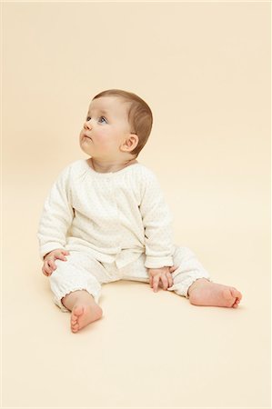 Studio portrait of distracted baby girl Stock Photo - Premium Royalty-Free, Code: 649-07280931