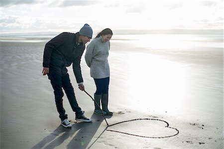 england - Young couple drawing heart in sand, Brean Sands, Somerset, England Stockbilder - Premium RF Lizenzfrei, Bildnummer: 649-07281046